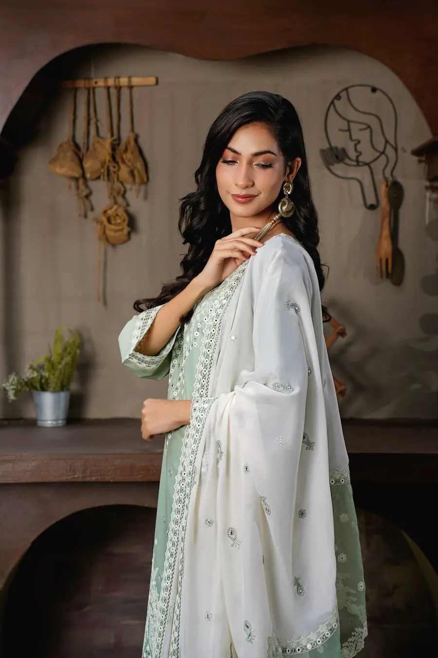 A woman in a mint suit with a white embroidered dupatta
